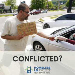conflicted? with homeless id project logo. a man holding a sign asking for help